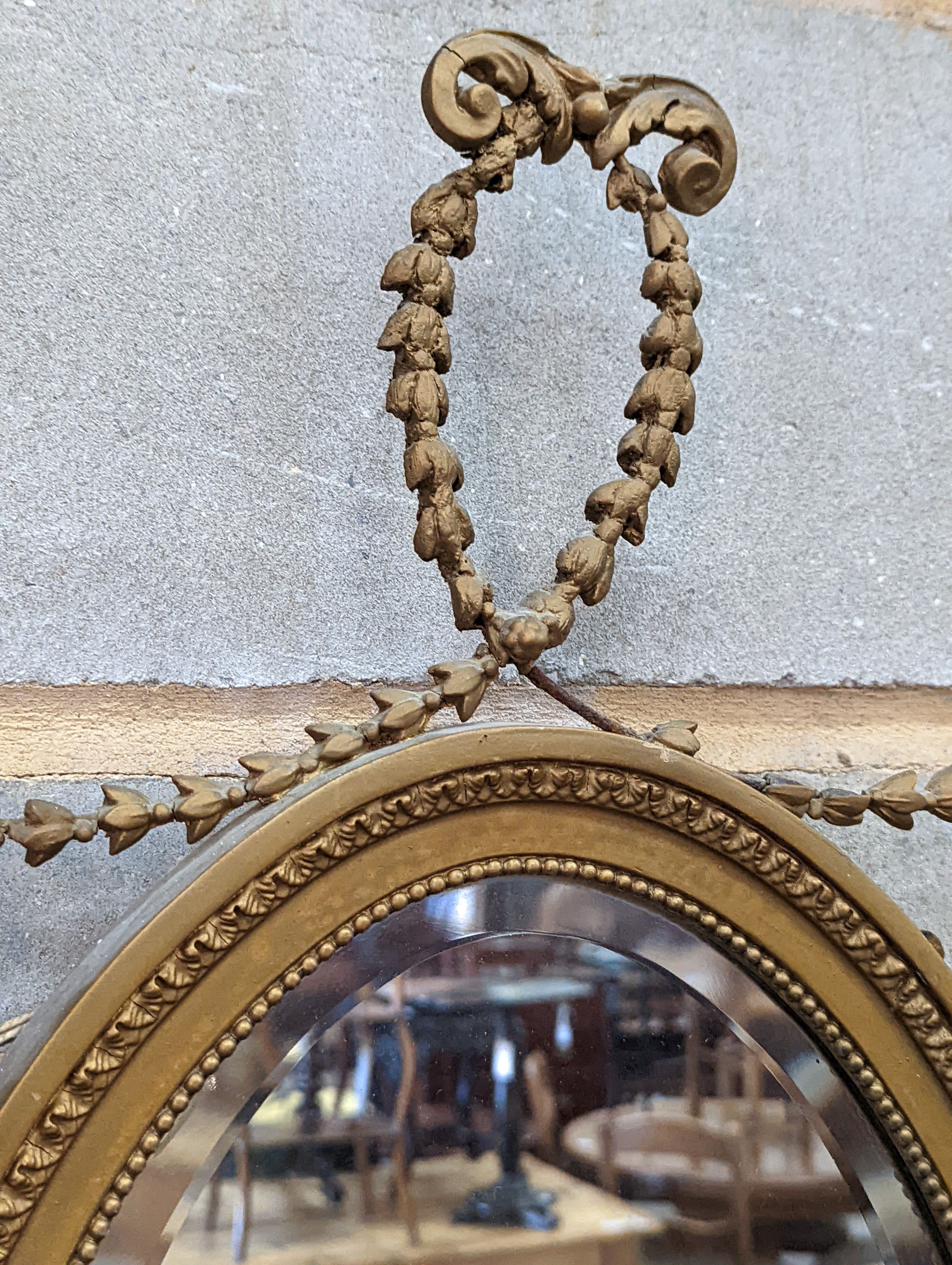 A pair of Edwardian Adam design oval giltwood and gesso wall mirrors, width 43cm, height 80cm